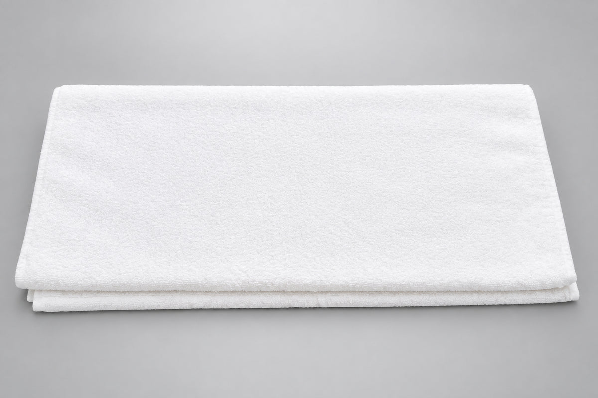 Hotel White Bath Towel laid flat on a wooden surface
