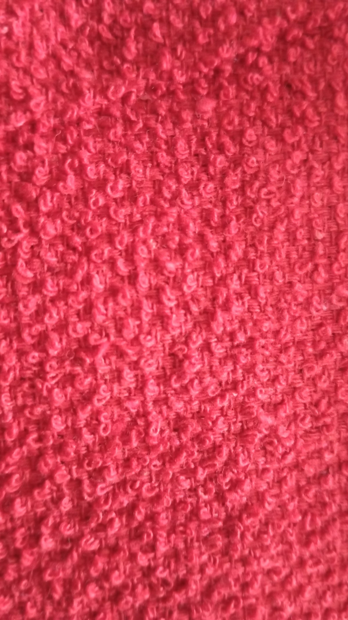 Macro close-up of the loop terry pile in a pink-coral shade