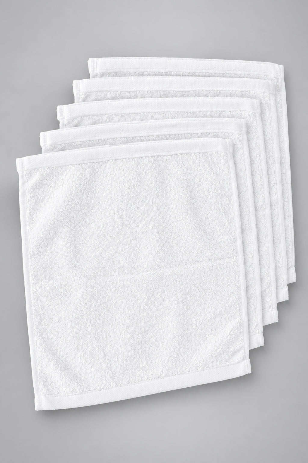 Six White Washcloths fanned out, top view