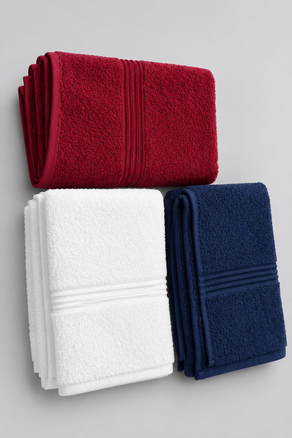 Hot Pink, White and Slate Blue Gym and Face Towels arranged on a wooden table