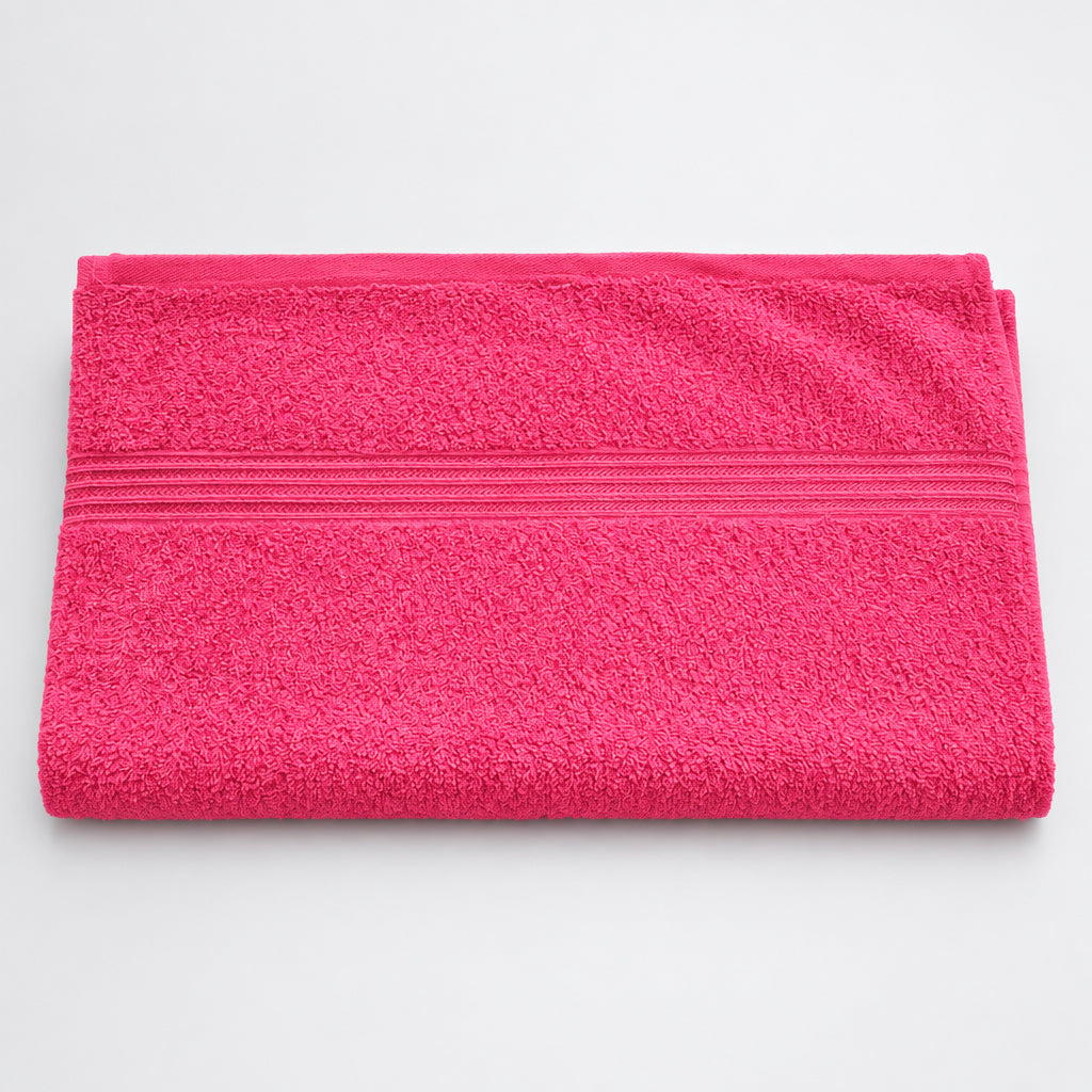 Hot Pink Gym and Face Towel laid flat on a light background, showing the woven border