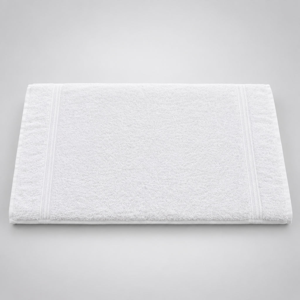 White Gym and Face Towel laid flat on a dark wooden table