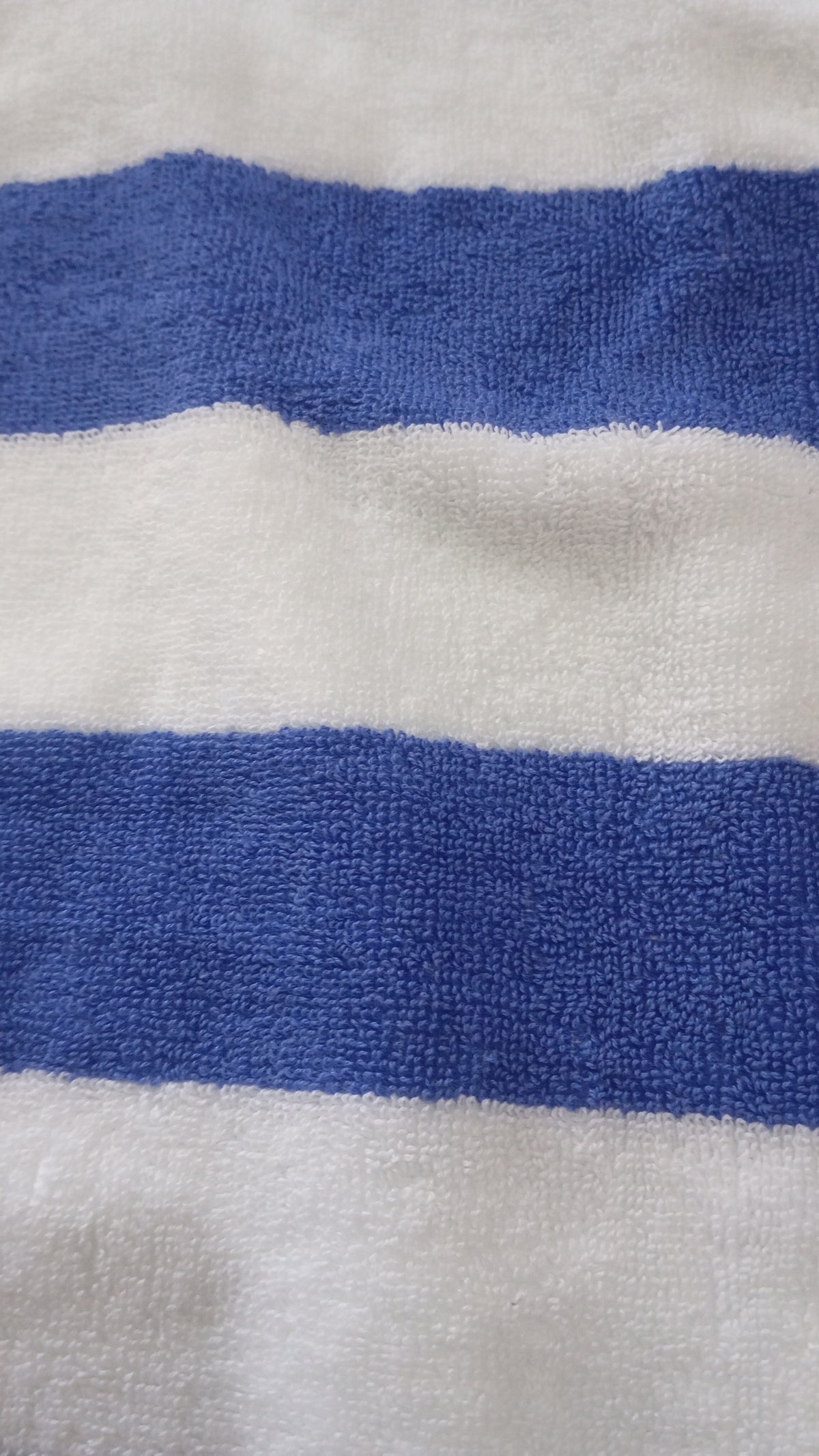 Close-up of the terry loops on the Cabana Stripe Pool Towel, alternating white and royal blue bands