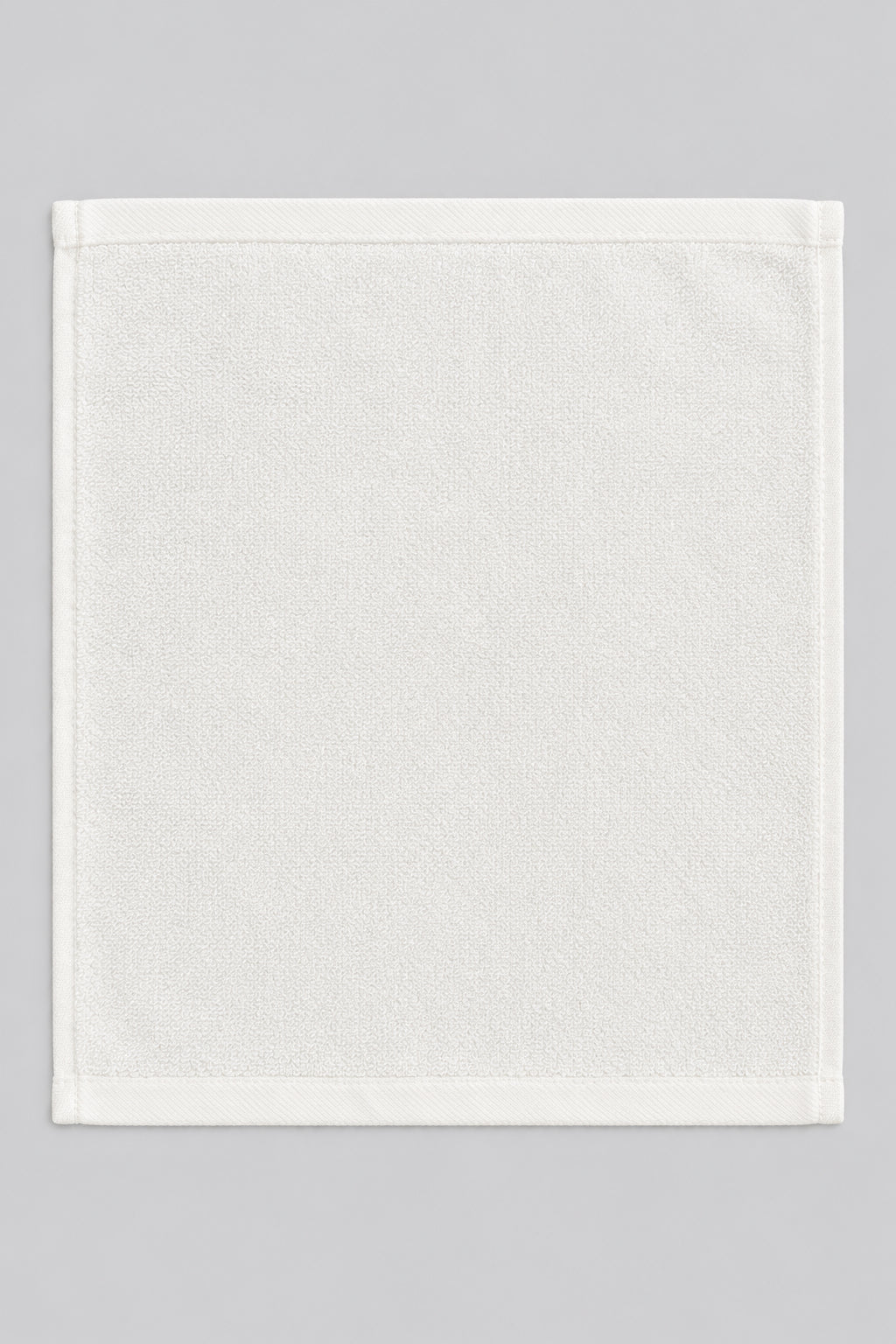 Single White Washcloth laid flat, top view