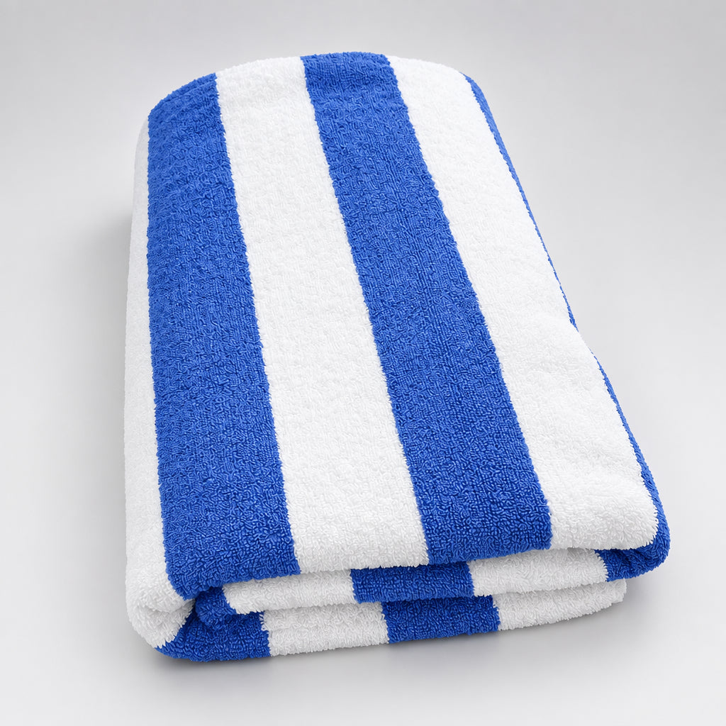 Cabana Stripe Pool Towel folded on a wooden table, side view