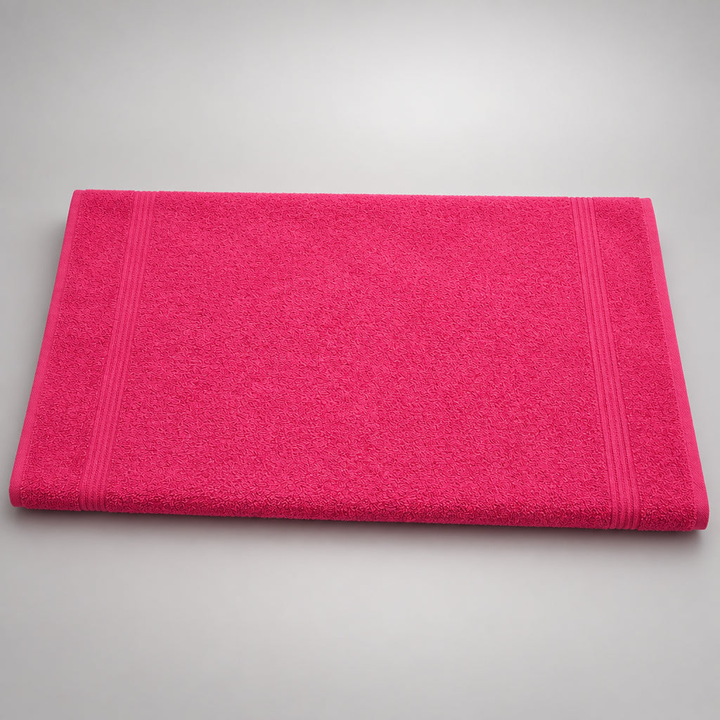 Hot Pink Gym and Face Towel laid flat on a wooden table