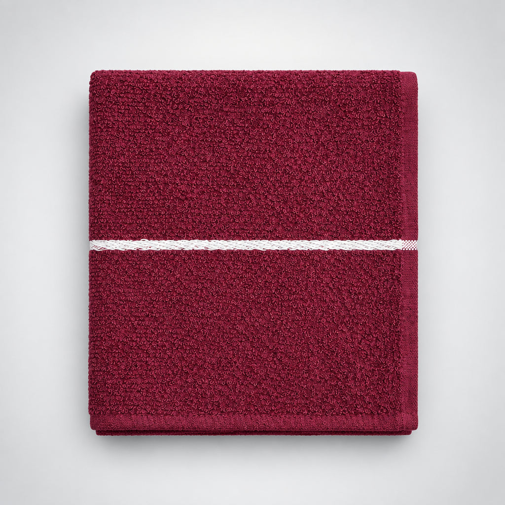 Burgundy Loop Terry Kitchen Towel folded on a wooden table