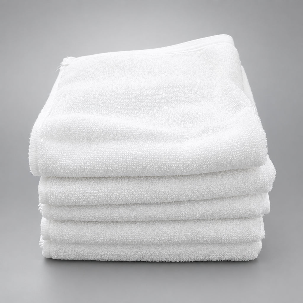 Stack of folded White Washcloths on a wooden table